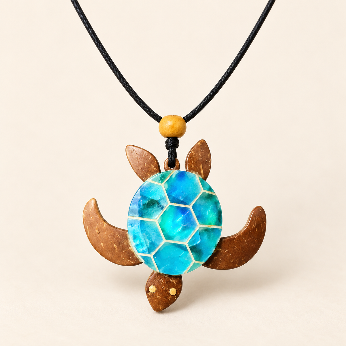 Blue Sea Turtle Coconut Shell Pendant Necklace, studio view showing pendant, bead and black cord on ivory background
