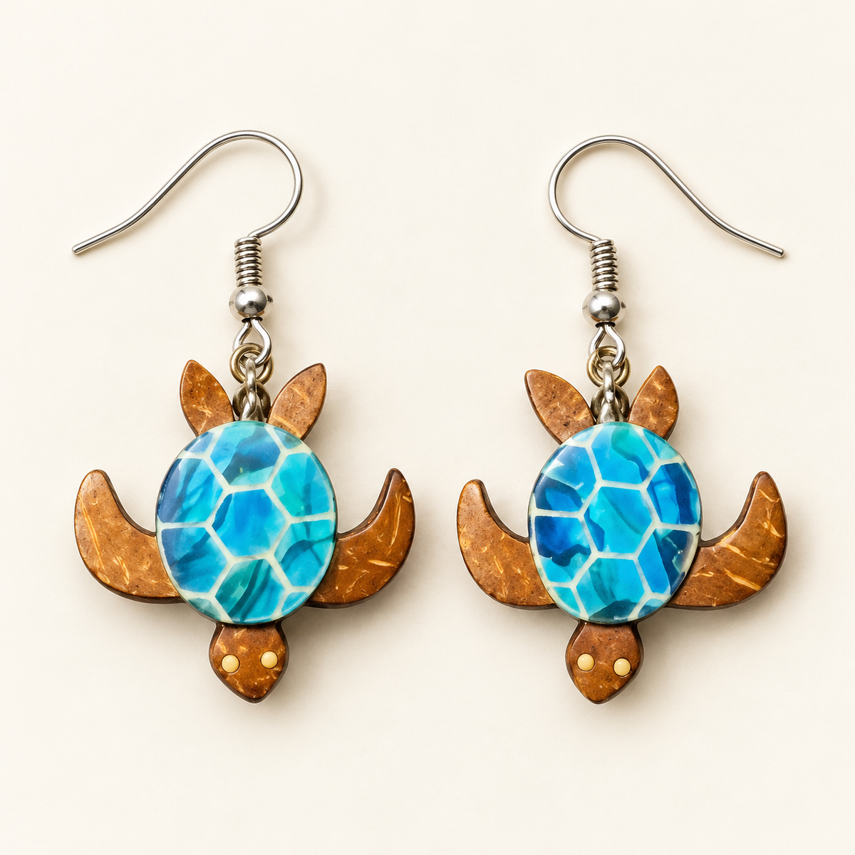 Blue Sea Turtle Coconut Shell Dangle Earrings, matching pair with hook fittings on ivory background