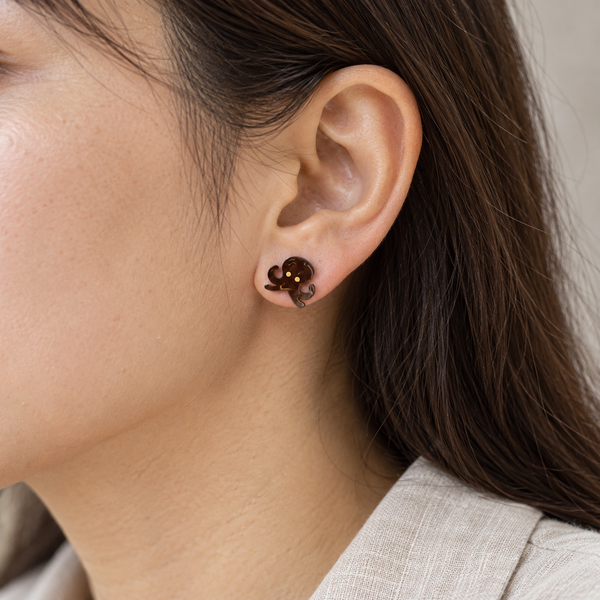 Brown Octopus Stud Earrings, worn by an adult woman