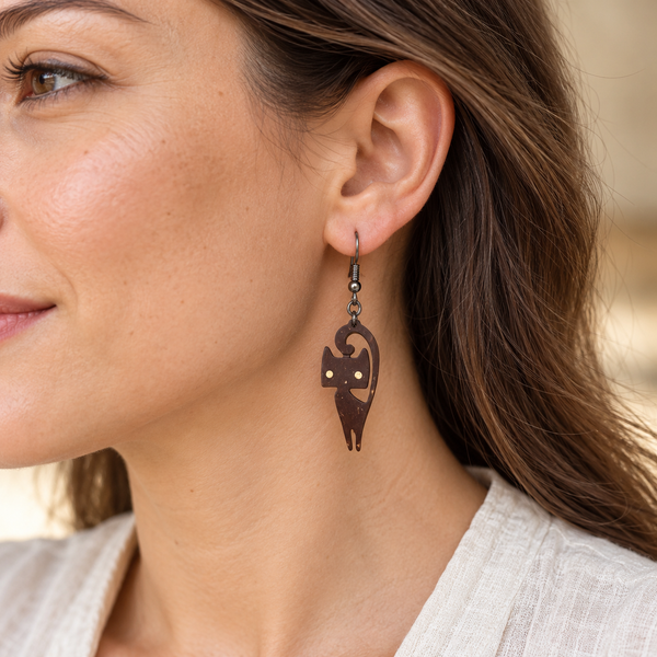 Curled-Tail Cat Coconut Shell Dangle Earrings, worn by an adult woman