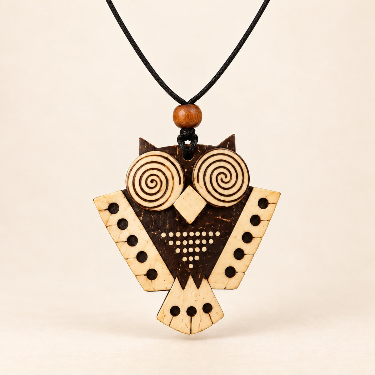 Forest Whisper coconut shell owl pendant necklace on a single black cord, front view