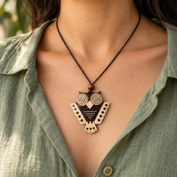 Woman wearing the Forest Whisper coconut shell owl pendant necklace on a single black cord