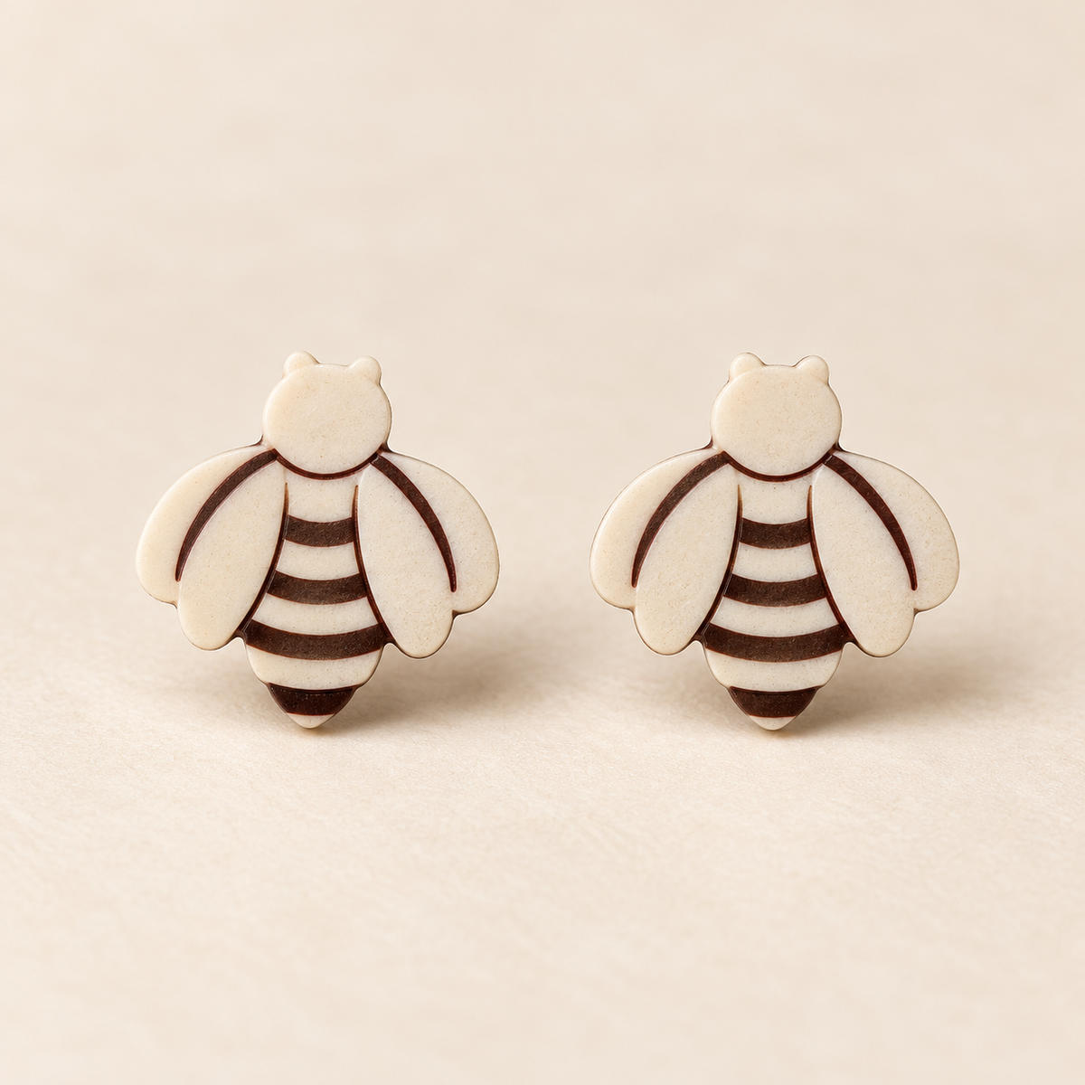 Ivory Bee Stud Earrings, pair on a clean ivory studio background