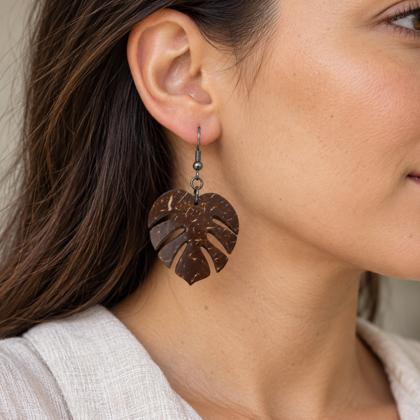 Monstera Leaf Coconut Shell Dangle Earrings, worn by an adult woman