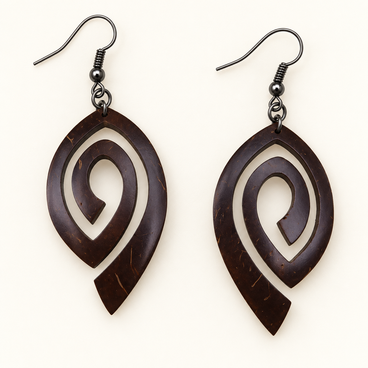Open Swirl Coconut Shell Dangle Earrings, studio pair with hook fittings on ivory background