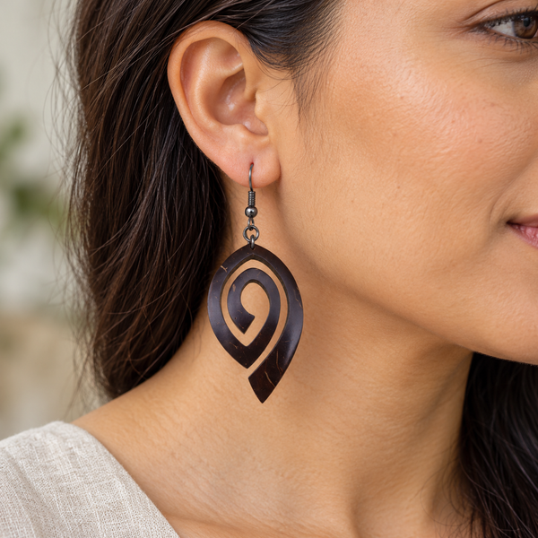 Open Swirl Coconut Shell Dangle Earrings, worn by an adult woman