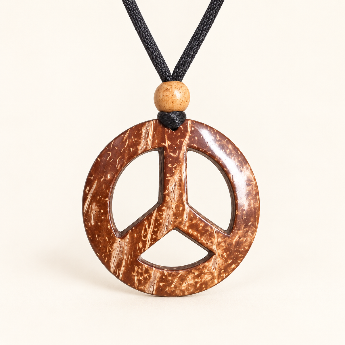 Peace Mark Coconut Shell Pendant Necklace, studio view showing pendant, bead and black cord on an ivory background