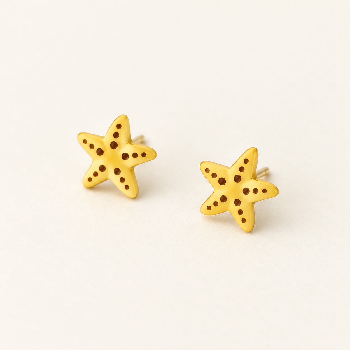 Yellow Starfish Stud Earrings, pair on an ivory studio background