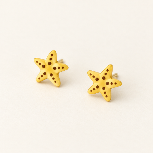 Yellow Starfish Stud Earrings, pair on an ivory studio background